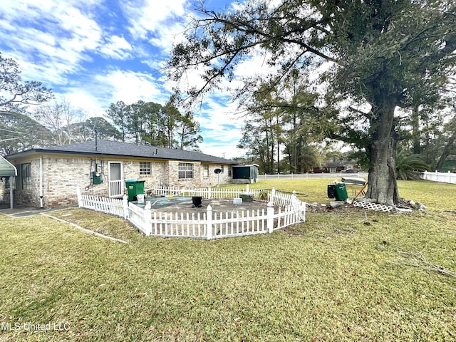 back of house featuring a patio area, fence, and a yard