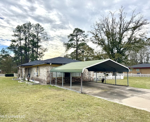 surrounding community featuring a yard, fence, and a detached carport