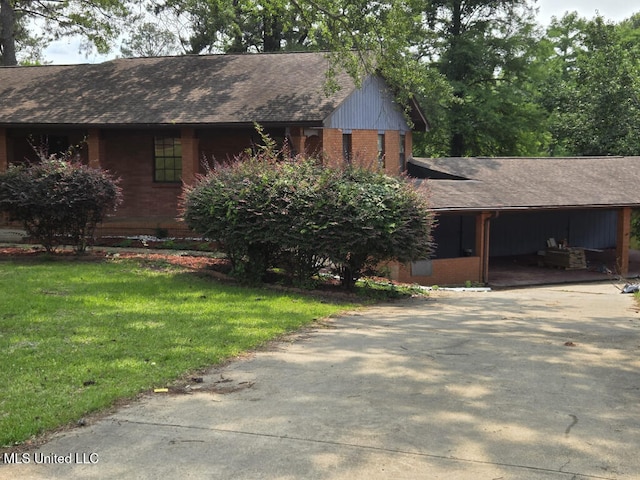329 Arapaho Ln, Madison, MS 39110 - view of front of home featuring roof with shingles, brick siding, a front lawn, and concrete driveway