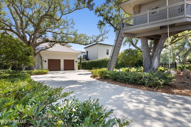 view of side of home featuring a balcony and a garage