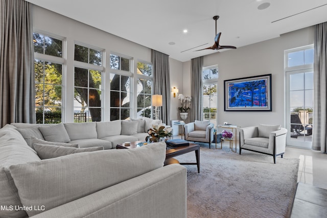 living room with a wealth of natural light and ceiling fan