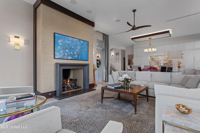 living room featuring ceiling fan with notable chandelier