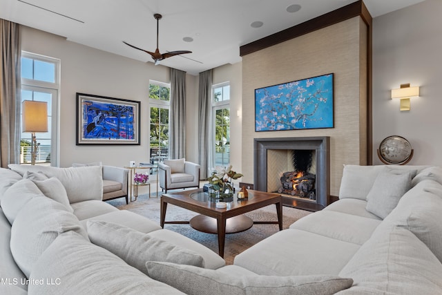 living room featuring ceiling fan and a wealth of natural light