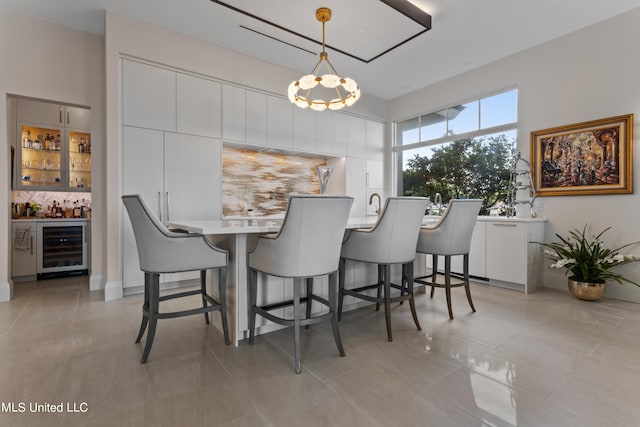 dining room with wine cooler, light tile patterned floors, and bar area