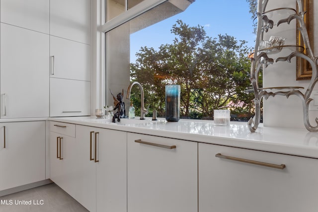 interior space featuring sink and tile patterned flooring