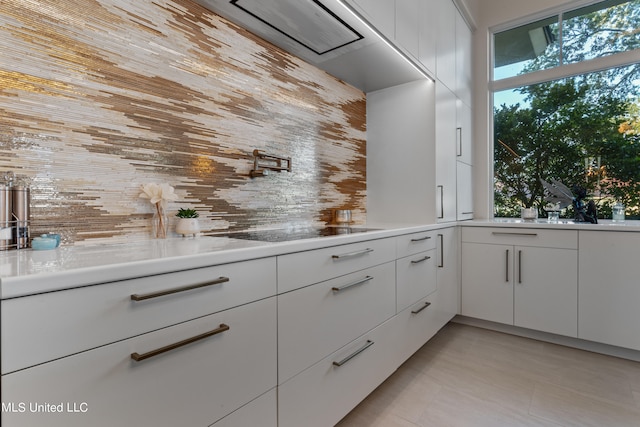 kitchen featuring white cabinetry and black electric cooktop