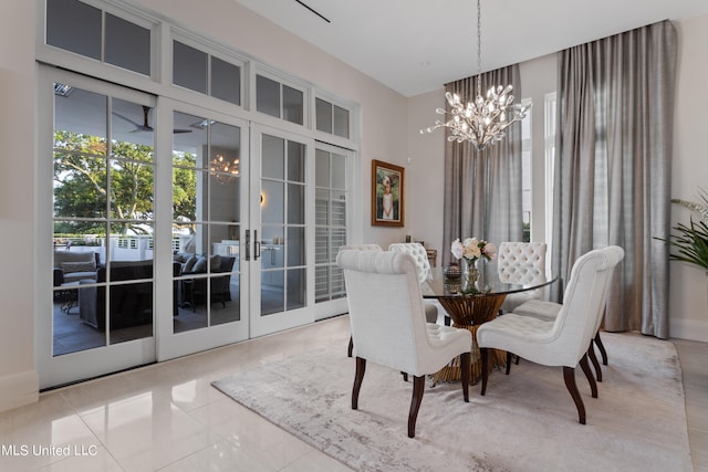 tiled dining area with french doors and a notable chandelier