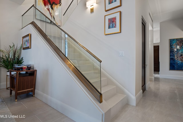 stairs with tile patterned floors