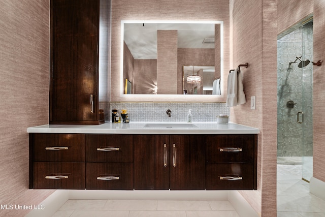 bathroom featuring vanity, backsplash, walk in shower, and tile patterned flooring