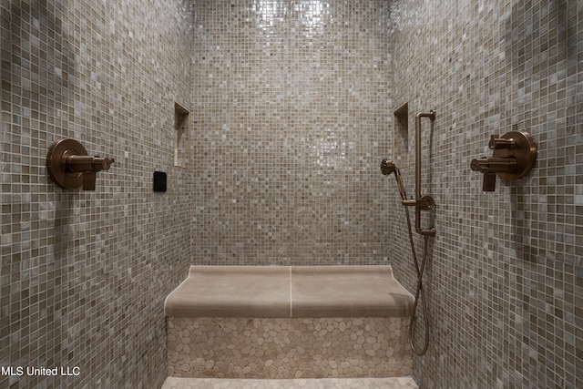 bathroom with a tile shower