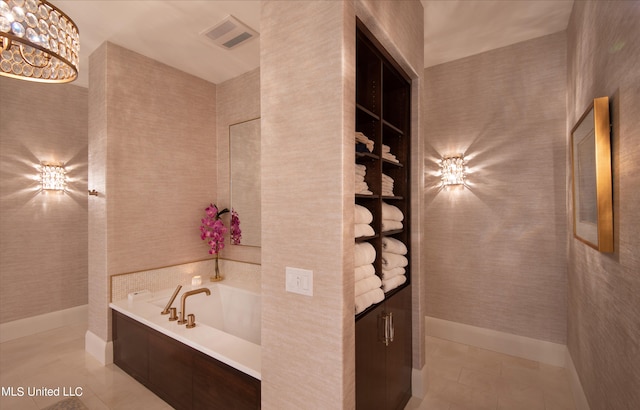 bathroom with a bathing tub and tile patterned flooring