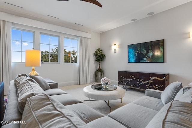 living room featuring light colored carpet and ceiling fan