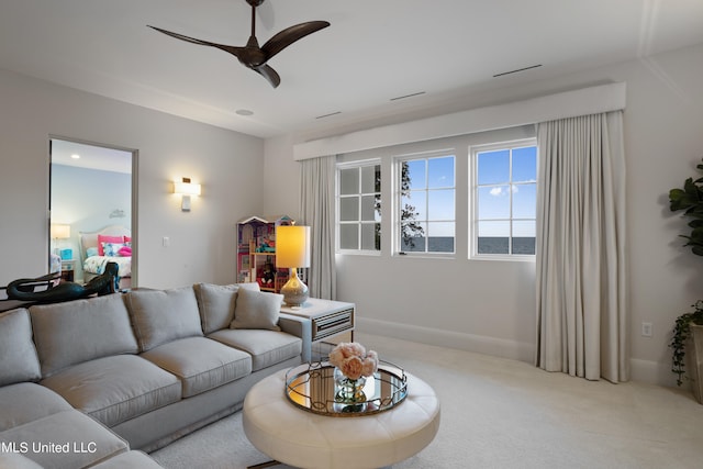 living room with light colored carpet and ceiling fan