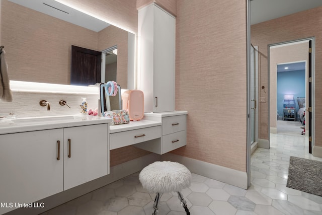 bathroom featuring vanity, backsplash, a shower with shower door, and tile patterned flooring