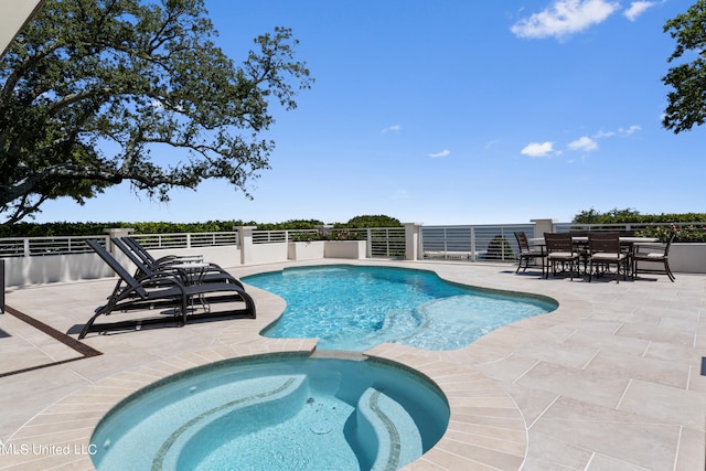 view of pool featuring an in ground hot tub and a patio