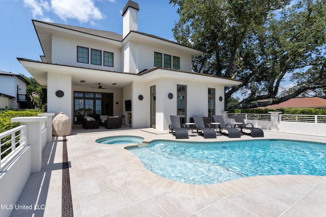 rear view of house featuring a swimming pool with hot tub, an outdoor hangout area, a patio area, and ceiling fan