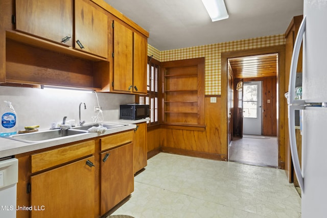 kitchen with wallpapered walls, light floors, brown cabinets, white appliances, and open shelves