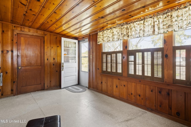 entryway featuring wooden walls and wood ceiling