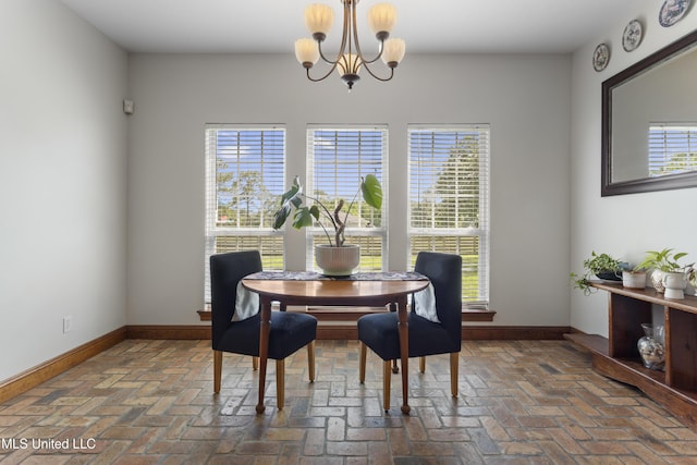 12219 County Farm Rd, Gulfport, MS 39503 - dining space featuring a chandelier and brick floors