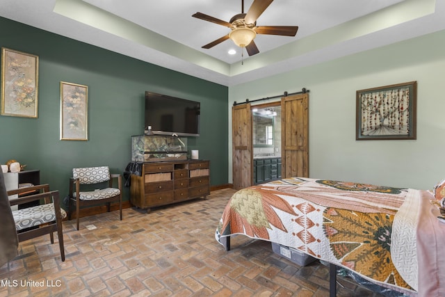 12219 County Farm Rd, Gulfport, MS 39503 - bedroom with a raised ceiling, a barn door, recessed lighting, brick flooring, and connected bathroom