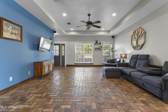 12219 County Farm Rd, Gulfport, MS 39503 - living area with ceiling fan, a raised ceiling, brick floors, and recessed lighting