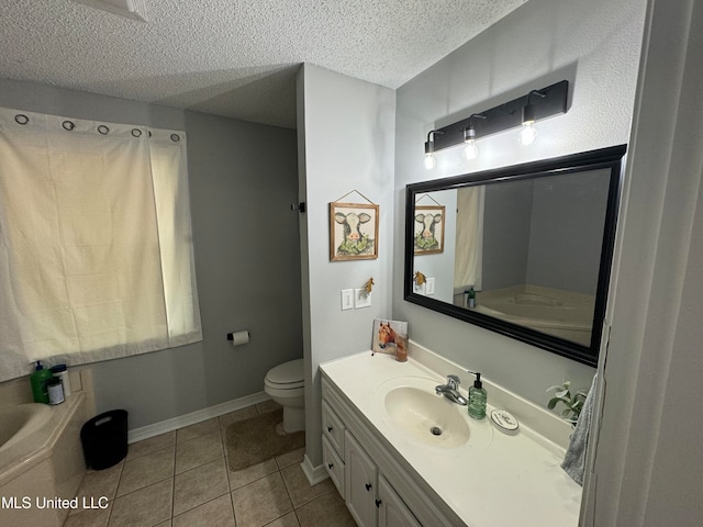 bathroom featuring vanity, toilet, tile patterned floors, and a textured ceiling