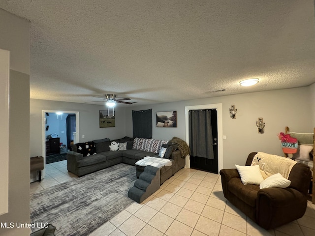 living room featuring ceiling fan, a textured ceiling, and light tile patterned floors