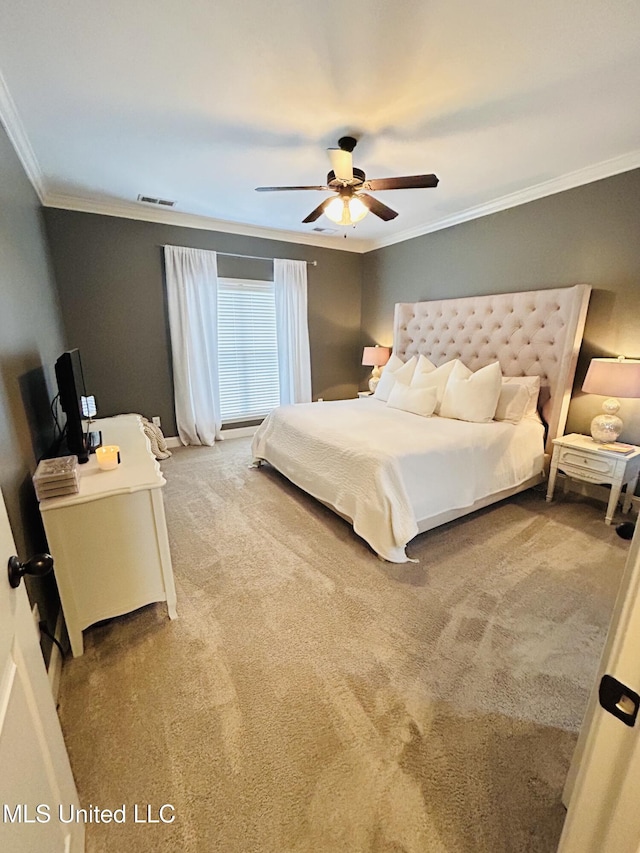 carpeted bedroom featuring ornamental molding and ceiling fan