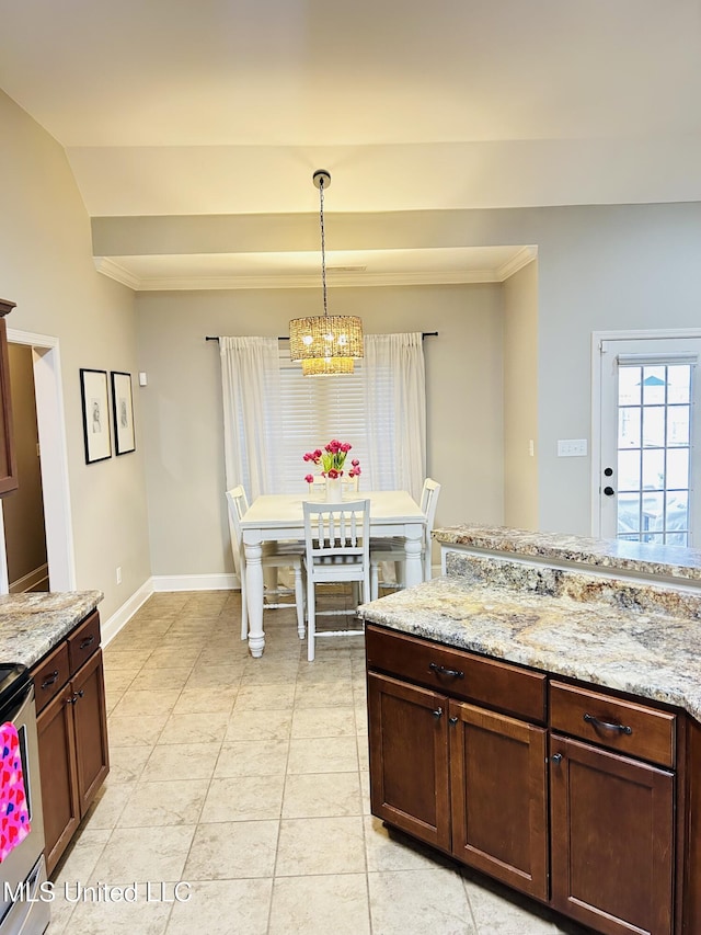 kitchen featuring hanging light fixtures, an inviting chandelier, light tile patterned floors, and light stone counters