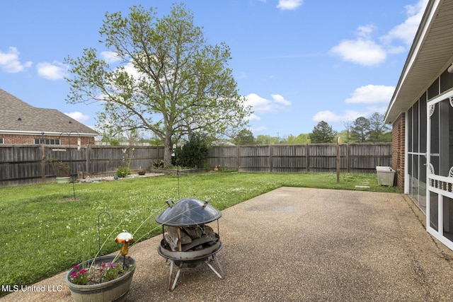 2120 Crossbridge Blvd, Byram, MS 39272 - view of yard featuring a patio area, a fenced backyard, a fire pit, and a sunroom
