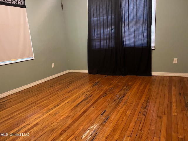 unfurnished room featuring hardwood / wood-style flooring