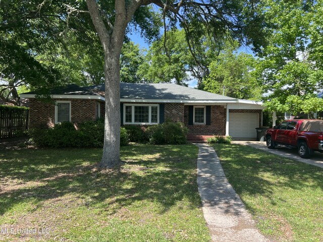 single story home featuring driveway, fence, a garage, brick siding, and a front yard