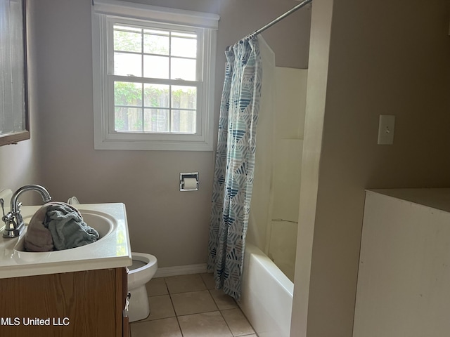 full bathroom with tile patterned flooring, toilet, vanity, baseboards, and shower / bath combo
