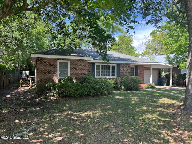 single story home featuring a front lawn and a garage