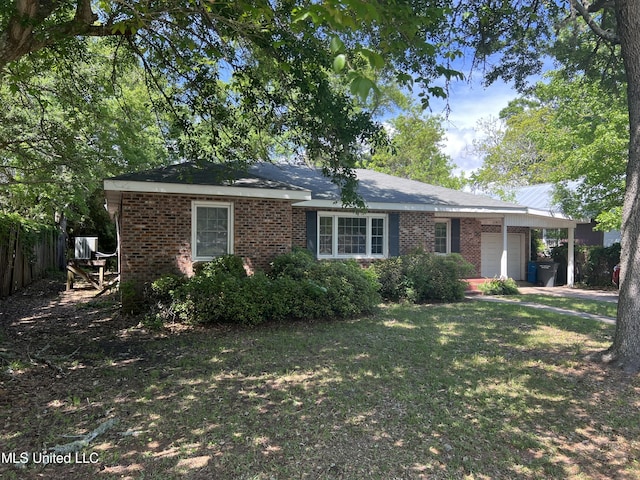 ranch-style home with a front lawn, brick siding, fence, and a garage
