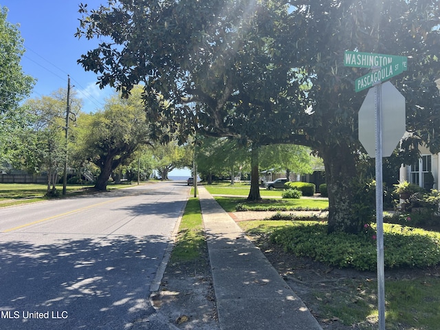 view of street featuring traffic signs and sidewalks