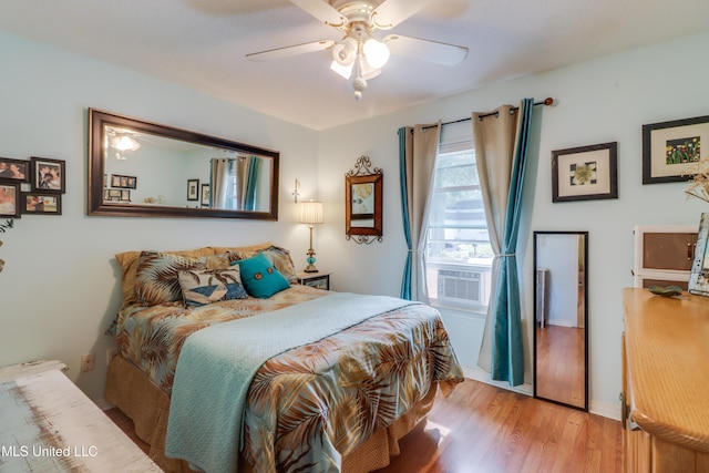 109 Palm Ave, Pass Christian, MS 39571 - bedroom with wood finished floors, cooling unit, and ceiling fan