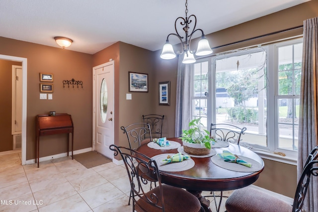 109 Palm Ave, Pass Christian, MS 39571 - dining area with plenty of natural light, a chandelier, baseboards, and light tile patterned floors