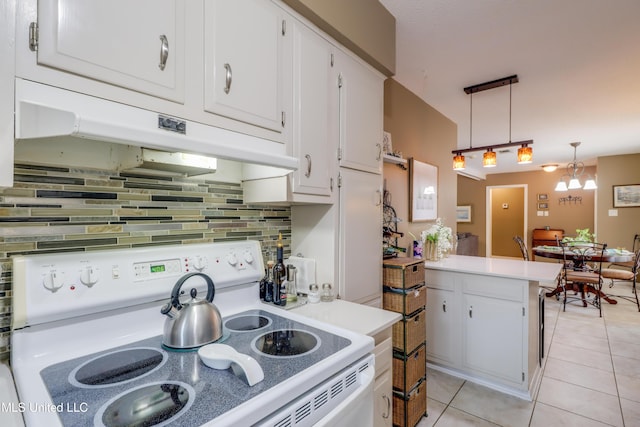 109 Palm Ave, Pass Christian, MS 39571 - kitchen with white electric range oven, light tile patterned flooring, a peninsula, and tasteful backsplash