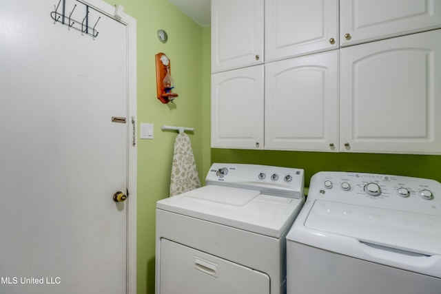 109 Palm Ave, Pass Christian, MS 39571 - laundry room with cabinet space and washing machine and clothes dryer