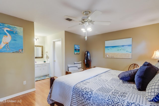109 Palm Ave, Pass Christian, MS 39571 - bedroom with wood finished floors, baseboards, connected bathroom, and ceiling fan