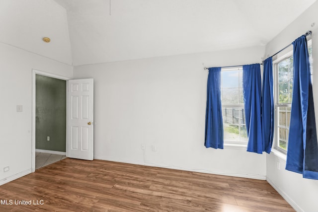 11318 Fairfield Ln, Gulfport, MS 39503 - spare room featuring vaulted ceiling and wood finished floors