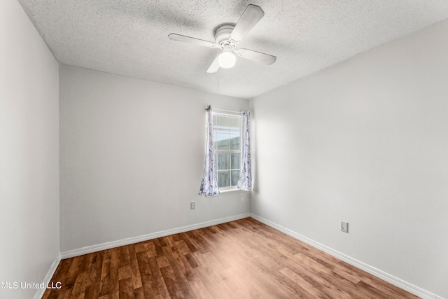 empty room with a textured ceiling, hardwood / wood-style flooring, and ceiling fan