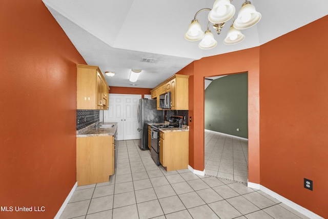 11318 Fairfield Ln, Gulfport, MS 39503 - kitchen with stainless steel appliances, tasteful backsplash, visible vents, a chandelier, and light tile patterned floors