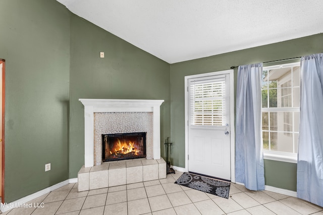 unfurnished living room with a textured ceiling, light tile patterned floors, and a fireplace