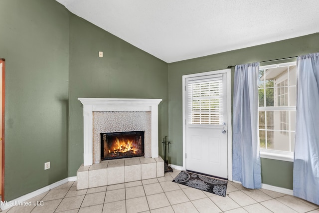 11318 Fairfield Ln, Gulfport, MS 39503 - interior space featuring lofted ceiling, baseboards, light tile patterned floors, and a tiled fireplace