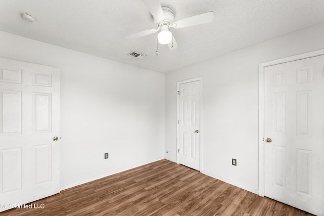 11318 Fairfield Ln, Gulfport, MS 39503 - unfurnished bedroom featuring baseboards, visible vents, a ceiling fan, and wood finished floors