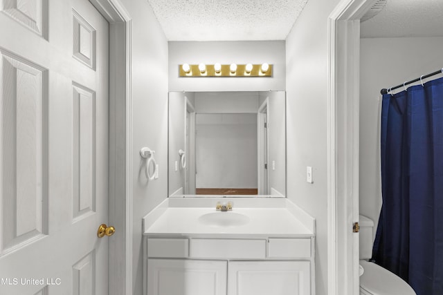 11318 Fairfield Ln, Gulfport, MS 39503 - bathroom featuring vanity, a textured ceiling, and toilet