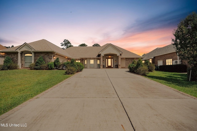 ranch-style home with a yard