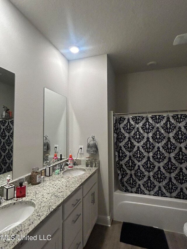 bathroom with vanity, wood-type flooring, and shower / bath combo with shower curtain